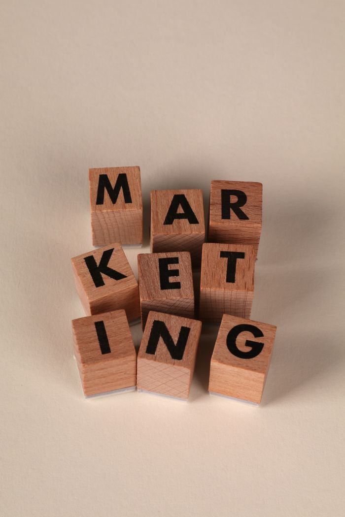 services-02 Wooden blocks arranged to spell 'MARKETING' on a neutral background.