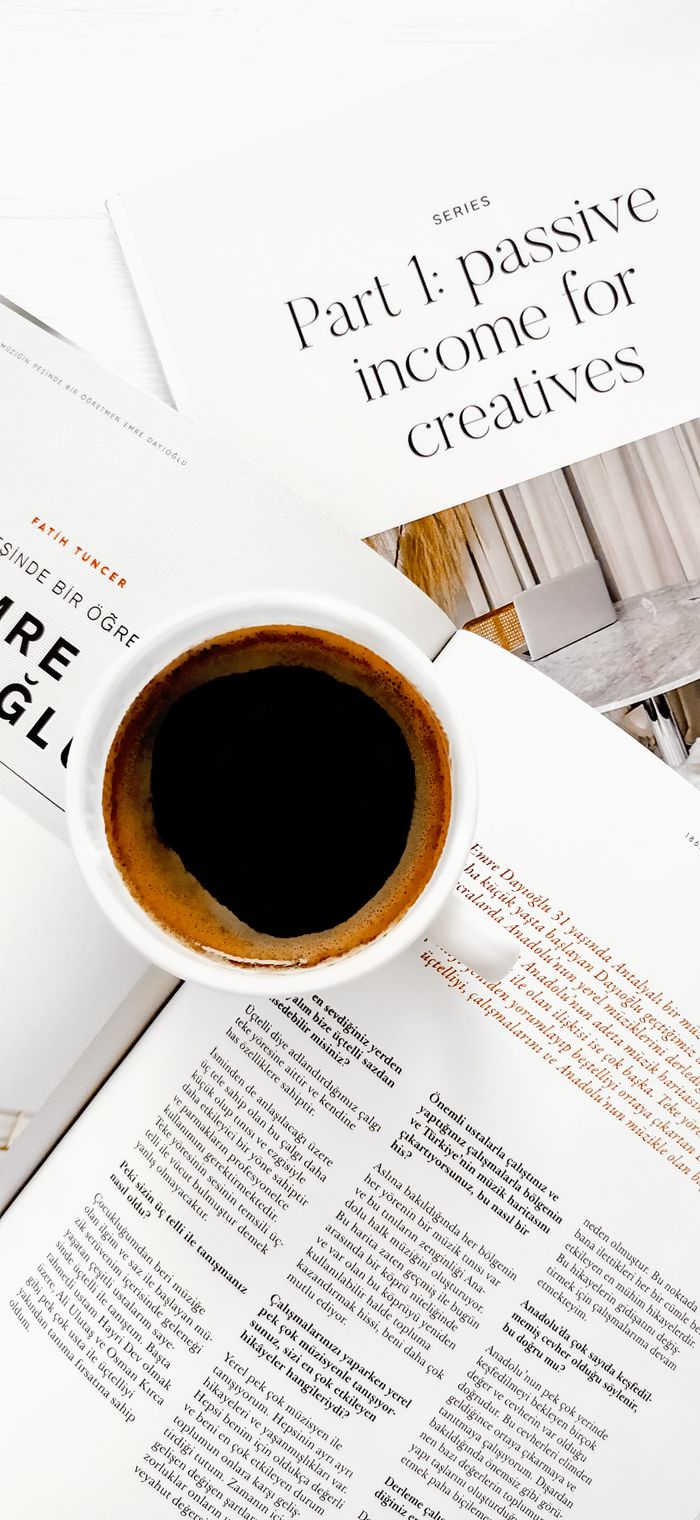 about-01 Cup of coffee on papers about passive income, perfect for creative work environments.